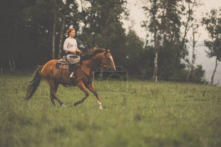 Photo for Pretty, young, redhead woman with her lovely horse, during her favorite leisure - Royalty Free Image
