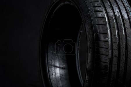 Photo for Stack of brand new high performance car tires on clean high-key white studio background - Royalty Free Image