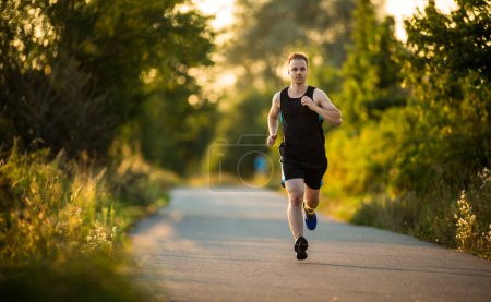 Photo for Shot of a young male athlete training on a race track. Sprinter running on athletics tracks seen from above - Royalty Free Image