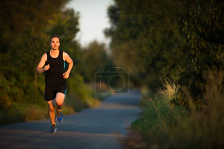 Photo for Shot of a young male athlete training. Getting his daily dose of mileage, to stay fit and lean. - Royalty Free Image