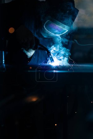 Photo for Man working on iron with grinder. Man at work. Sparkles and fire from grinder cutting. Grinder. Worker. - Royalty Free Image