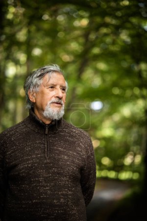 Photo for Elderly caucasian male walking outdoors on an autumn, fall day - Royalty Free Image