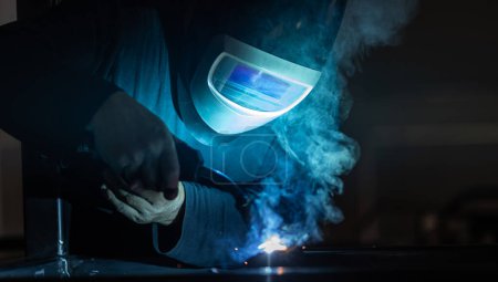 Photo for Man working on iron with grinder. Man at work. Sparkles and fire from grinder cutting. Grinder. Worker. - Royalty Free Image