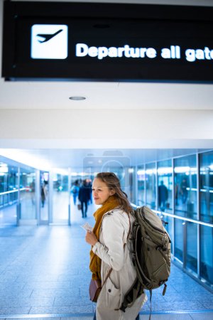 Photo for Canceled flight situation - Young, pretty female traveler learning about her flight being canceled, unable to get home today - Royalty Free Image