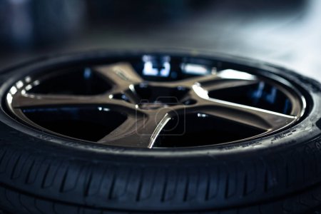 Téléchargez les photos : Bande de roulement de pneu automobile avec une profondeur et une lumière dans l'obscurité, mise au point sélective - en image libre de droit