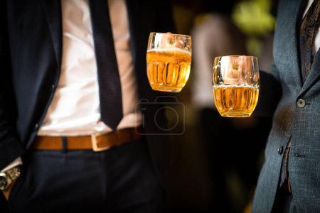 Photo for People drinking beer together at a company party, well dressed. - Royalty Free Image