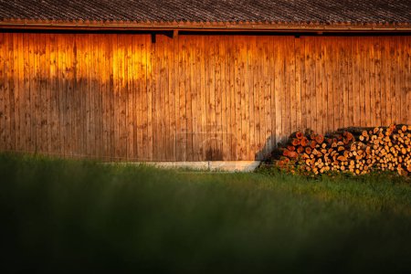 Photo for Dusk settles over hillside barn. Evening warm sunlight hitting a wooden barn. - Royalty Free Image
