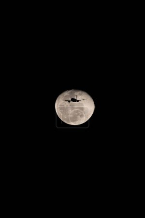 Téléchargez les photos : Un avion passe devant la lune de ver le 9 mars 2023, à l'aéroport international Fort Lauderdale Hollywood à Fort Lauderdale, Floride. - en image libre de droit