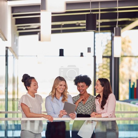 Multi-Cultural Female Business Team With Digital Tablet Meeting Inside Modern Office Building