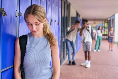 Unhappy Teenage Girl Outdoors At High School Being Teased Or Bullied