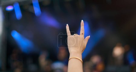 Close Up Of Person Making Rock And Roll Hand Gesture At Outdoor Summer Music Festival