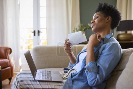 Menopause reif frau bei zuhause mit laptop having hot flush fanning selbst