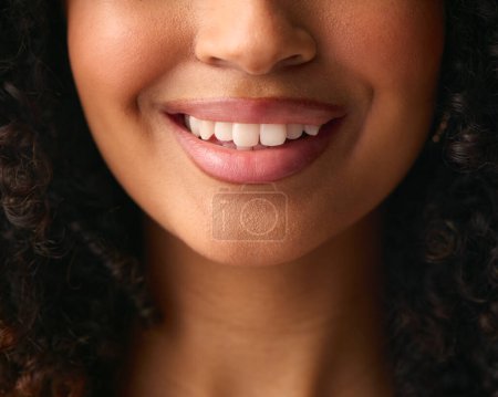 Close Up Studio Portrait Showing Mouth And Teeth Of Smiling Natural Woman