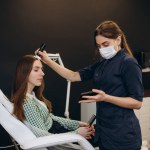 Consultation with a dermatologist. A trichologist examines the hair of a woman