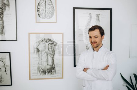 Photo for Experienced vertebrologist explaining the spine anatomy basics to a patient - Royalty Free Image