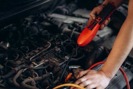 Photo for Technician check car air conditioning system refrigerant recharge, Repairman holding monitor tool to check and fixed car air conditioner system, Air Conditioning Repair. High quality photo - Royalty Free Image