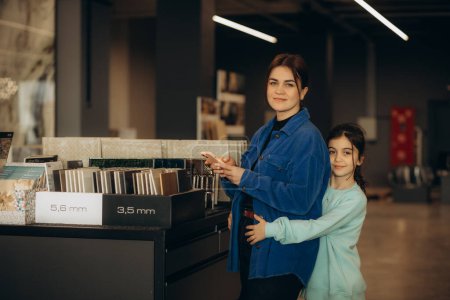 mother and daughter choose tiles for home. High quality photo