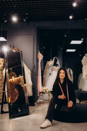 a woman consultant in a wedding dress shop