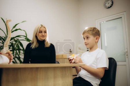 a little boy with his mother at a doctor's appointment