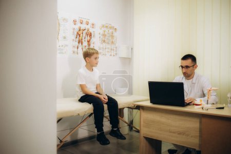 Photo for The husband's osteopath examines the child - Royalty Free Image