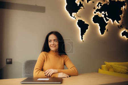 Photo for Female travel agent in the office at the laptop - Royalty Free Image