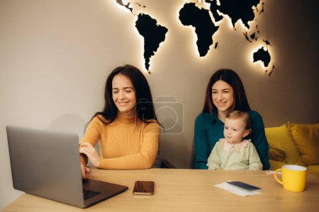 mother and daughter choose a tourist tour in a travel agency