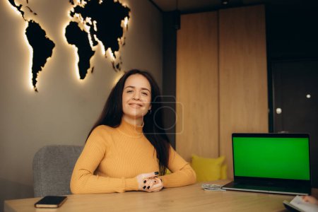 Photo for Female travel agent in the office at the laptop - Royalty Free Image
