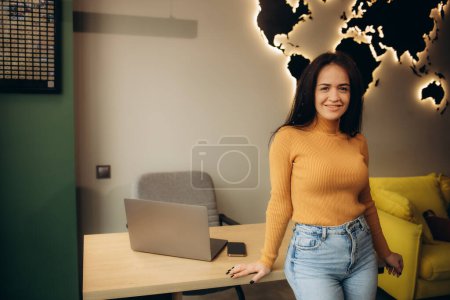 a woman in a travel agency against a background of a wooden world map