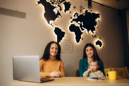 a young mother with her daughter in a travel agency