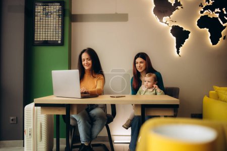 a young mother with her daughter in a travel agency