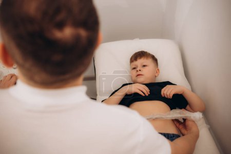 Photo for Little boy undergoing gastric and oesophageal ultrasound - Royalty Free Image