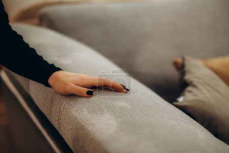 Photo for Joyful woman in furniture center chooses best sofa for her apartment - Royalty Free Image