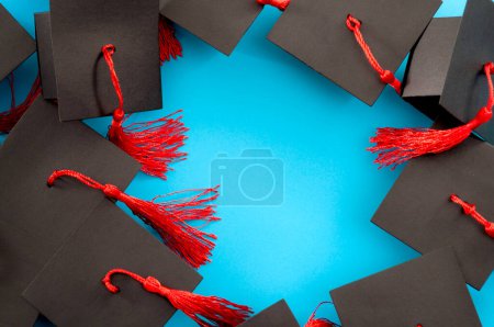 Photo for Many Graduation Caps Isolated on Blue Background with Copy Space Concept for University Celebrations, Degree Completion, College Graduating Poster and Celebrating Academic Success and Achievements - Royalty Free Image
