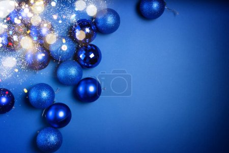 Christmas flat lay scene with glass balls in classic blue color with bokeh