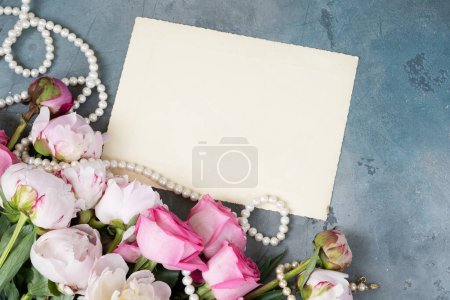 Fresh peonies flowers, close up view, summer background, copy space on blank card