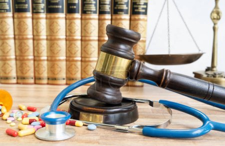 view of law gavel, stethoscope and pills, medical law concept