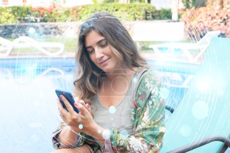 woman talking on mobile in relaxed ambient, happy woman using modern mobile on her vacations near pool