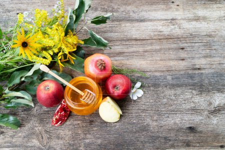 Photo for Rosh hashana holiday - honey jar with apples and pomergranates on rustic background, top view with copy space - Royalty Free Image