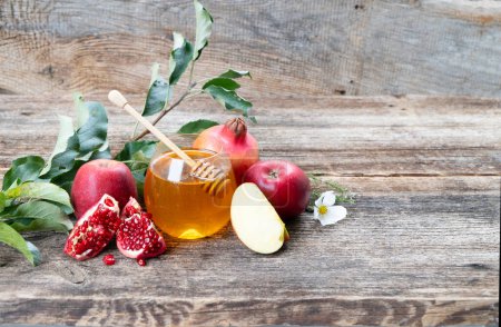 Photo for Rosh hashana holiday - honey jar with apples and pomergranates on rustic background - Royalty Free Image
