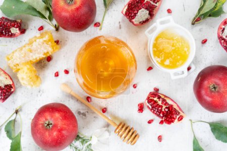 Photo for Rosh hashana holiday - honey with apple and pomergranate over white desk background - Royalty Free Image