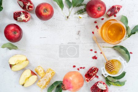 Photo for Rosh hashana holiday - honey with apple and pomergranate over white desk background. frame with copy space - Royalty Free Image