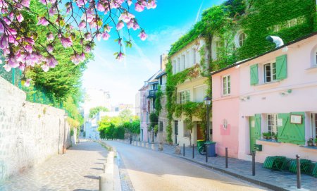 View of cosy street in quarter Montmartre in Paris, France. Cozy cityscape of Paris at summer. Architecture and landmarks of Paris.