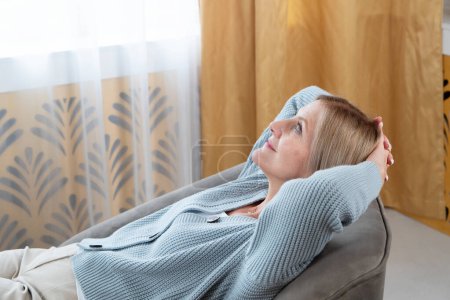 Blond senior woman relaxing and calming down, looking into the future concept and life balance