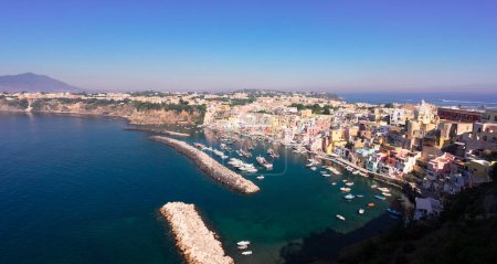 Procida island colorful town with small harbour from above, Italy, web banner format