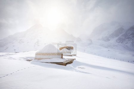Photo for Hotel and Restaurant from Yurt nomadic house complex at Ski resort Shymbulak in Almaty, Kazakhstan. Winter snowfall glow sun outdoor tourism concept. - Royalty Free Image