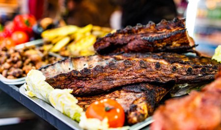 Photo for Barbecue grill meat ribs at street food market. Fresh cooking delicious bbq at traditional fair - Royalty Free Image