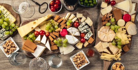 Téléchargez les photos : Variety of cheese kinds served with grape, honey and olives for gourmet nutrition. Organic parmesan, brie and camambert set with nuts - en image libre de droit