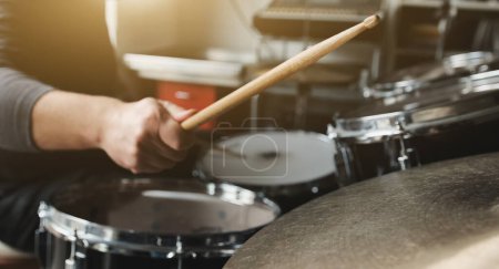 Photo for Drummer playing on drums and bronze cymbal plates with drumsticks live music. Musician during percussion instrumental perfomance - Royalty Free Image