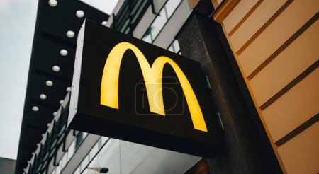 Téléchargez les photos : Belin, Germany - 20 December 2022: McDonalds symbol on a board in the city street - en image libre de droit