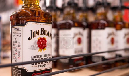 Photo for Whiskey Jim Beam bottles in supermarket with logo closeup. Alcohol strong beverage for party in store. Poznan, Poland, 2020-09-06 - Royalty Free Image